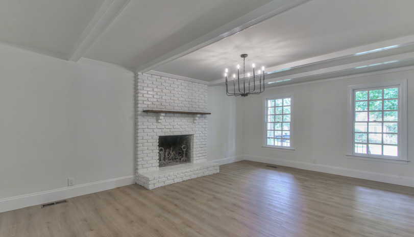 Living room with white-painted brick fireplace and beamed ceiling, Cottonwood Cir Franklin TN whole home remodel